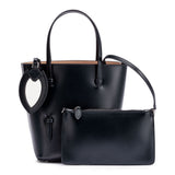 Navy leather tote with studded floral strap