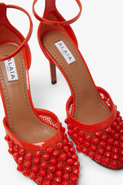 Red studded fishnet pumps