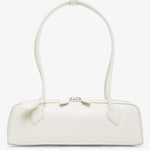 White handbag with a bow detail on a white background