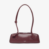 Maroon handbag on a light beige background