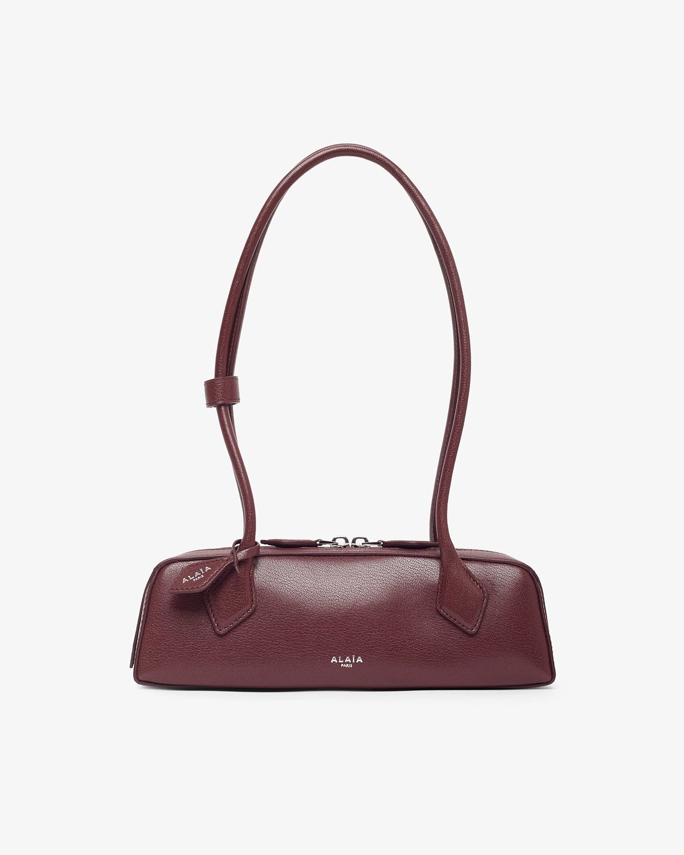 Maroon handbag on a light beige background