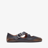 Brown leather shoe with a strap on a white background
