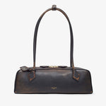 Brown leather handbag with a bow detail on a white background