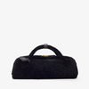 Black fur bag with a tag on a white background