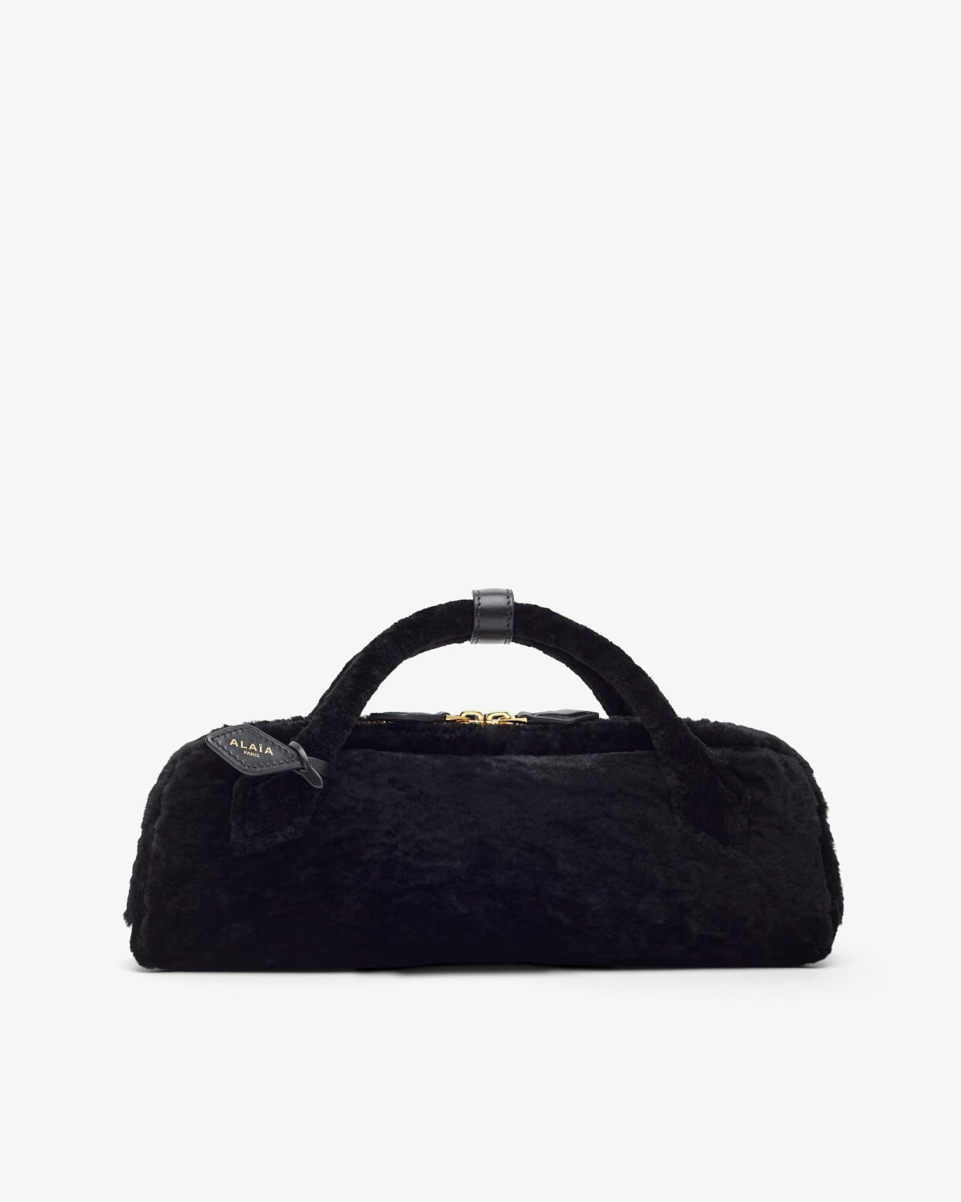 Black fur bag with a tag on a white background