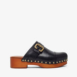 Black clog shoe with gold buckle and wooden sole on a white background