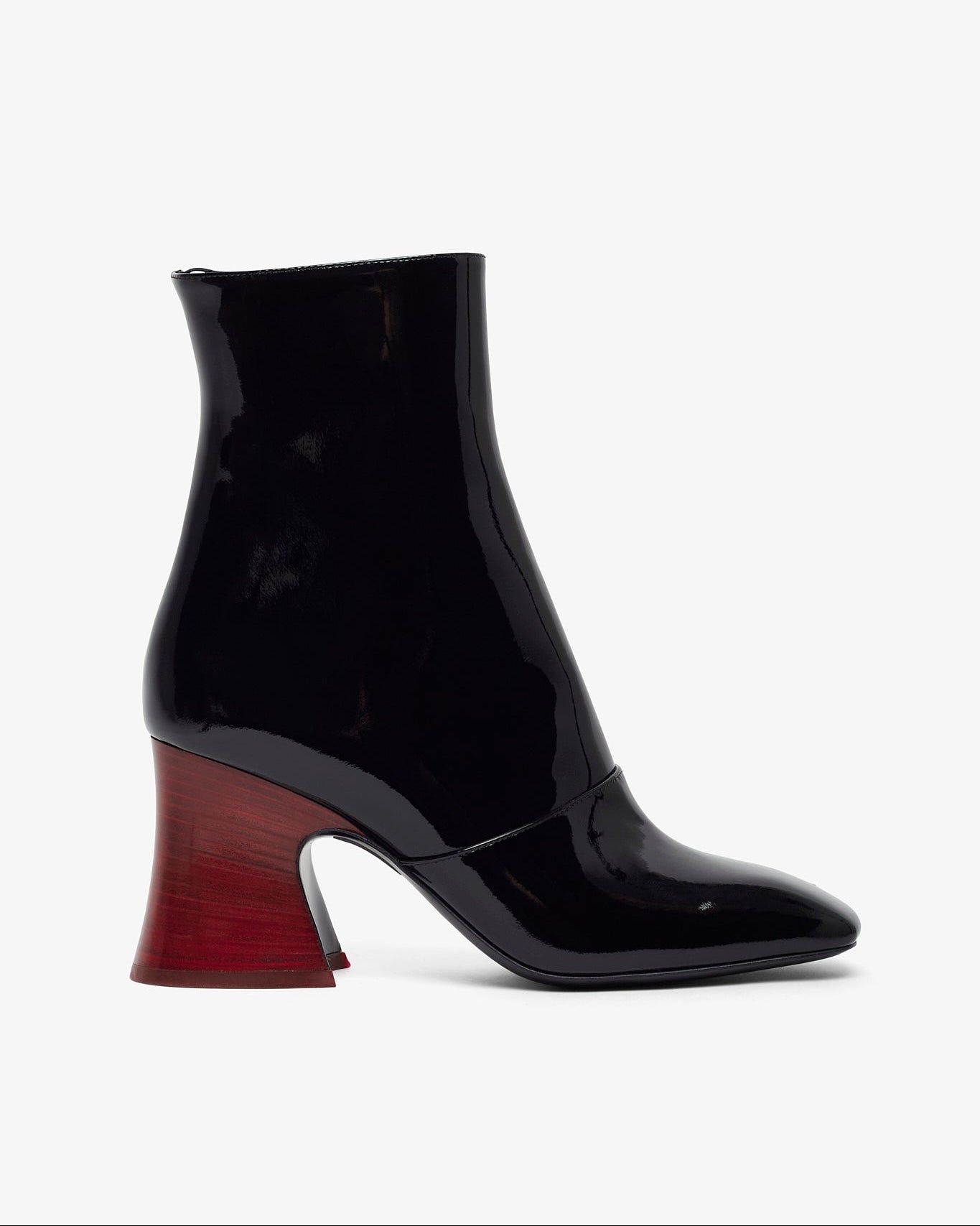 Black patent leather ankle boot with a red heel on a white background