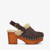 Brown suede clog with wooden sole and shearling trim on a white background