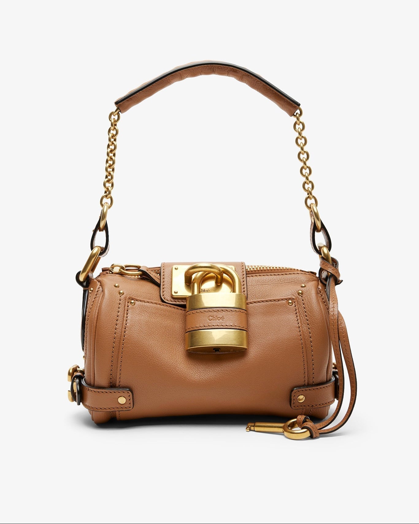 Tan handbag with gold accents on a white background