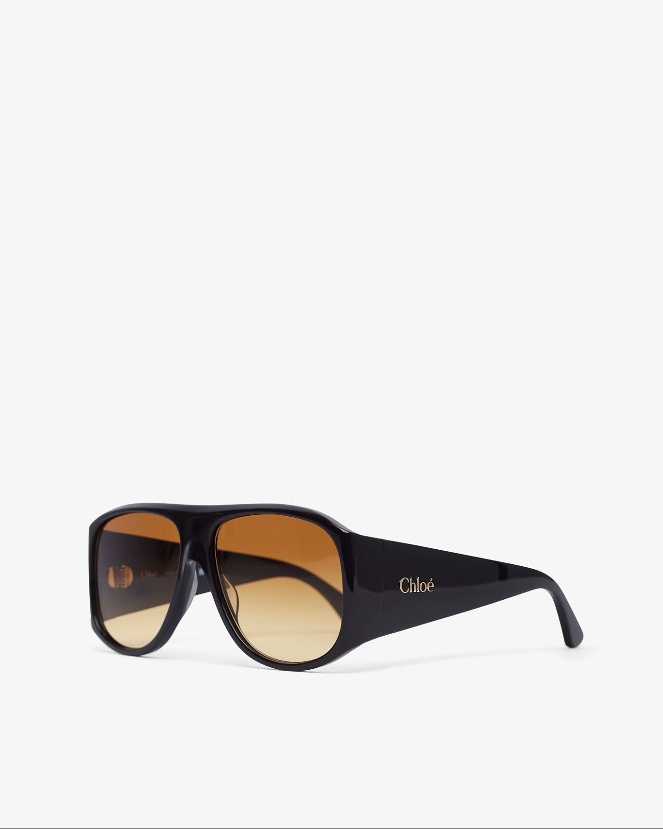 Black sunglasses with gold gradient lenses on a white background