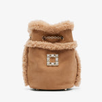 Brown fur-trimmed bag with a decorative clasp on a white background