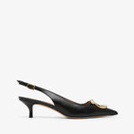 Black high-heeled shoes with a gold buckle on a white background