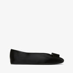 Black flat shoe with a bow on a white background