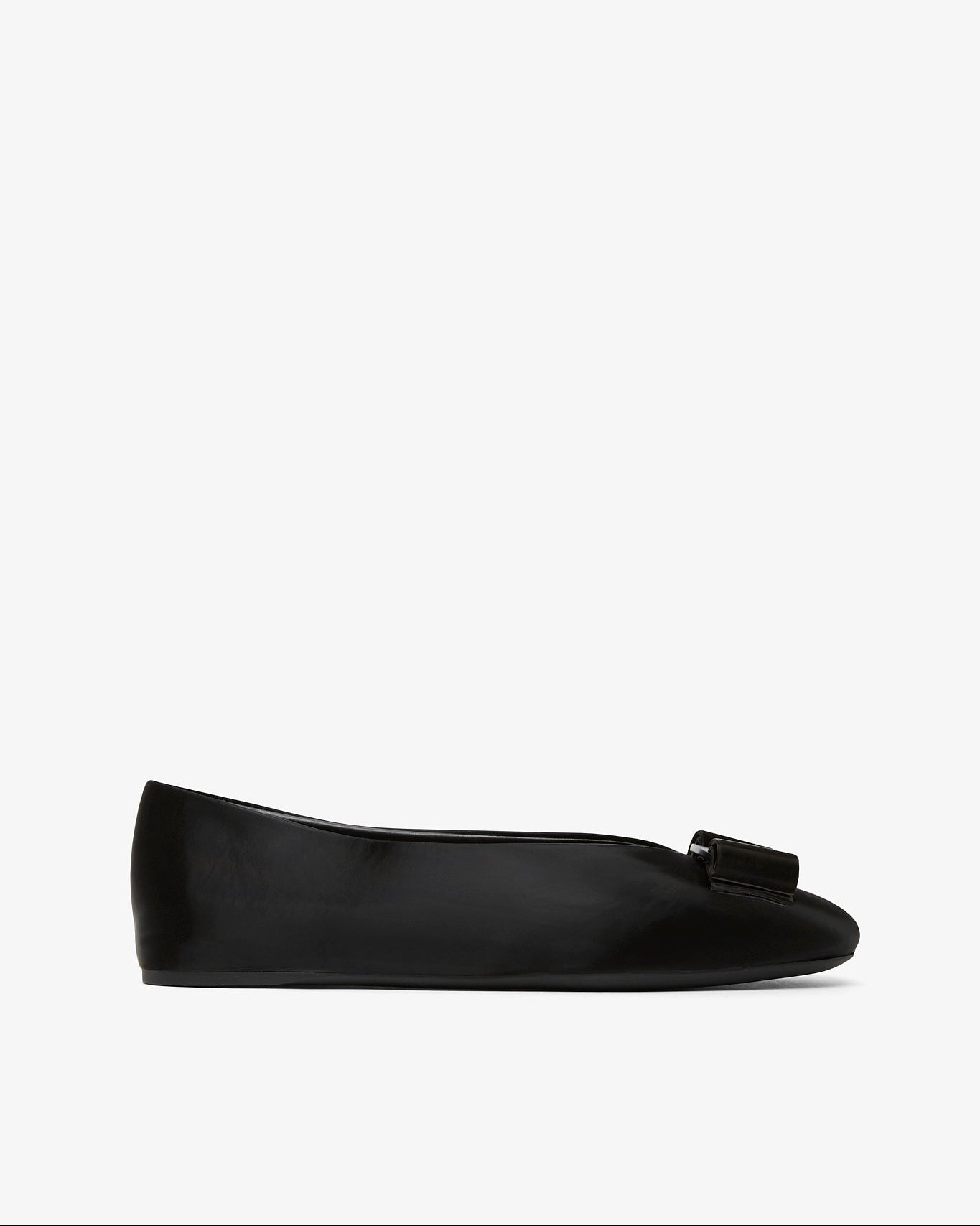 Black flat shoe with a bow on a white background