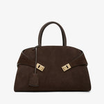 Brown handbag with gold hardware on a white background