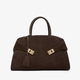Brown handbag with gold hardware on a white background