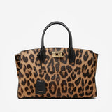 Leopard print handbag with black accents on a white background