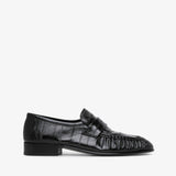 Black leather loafer on a white background
