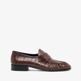 Brown leather loafer on a white background