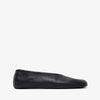 Black slip-on shoe on a white background
