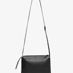 Black leather crossbody bag on a white background