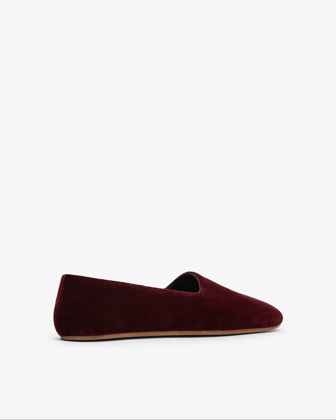 Burgundy velvet loafer on a white background