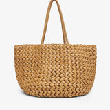 Woven straw tote bag on a white background